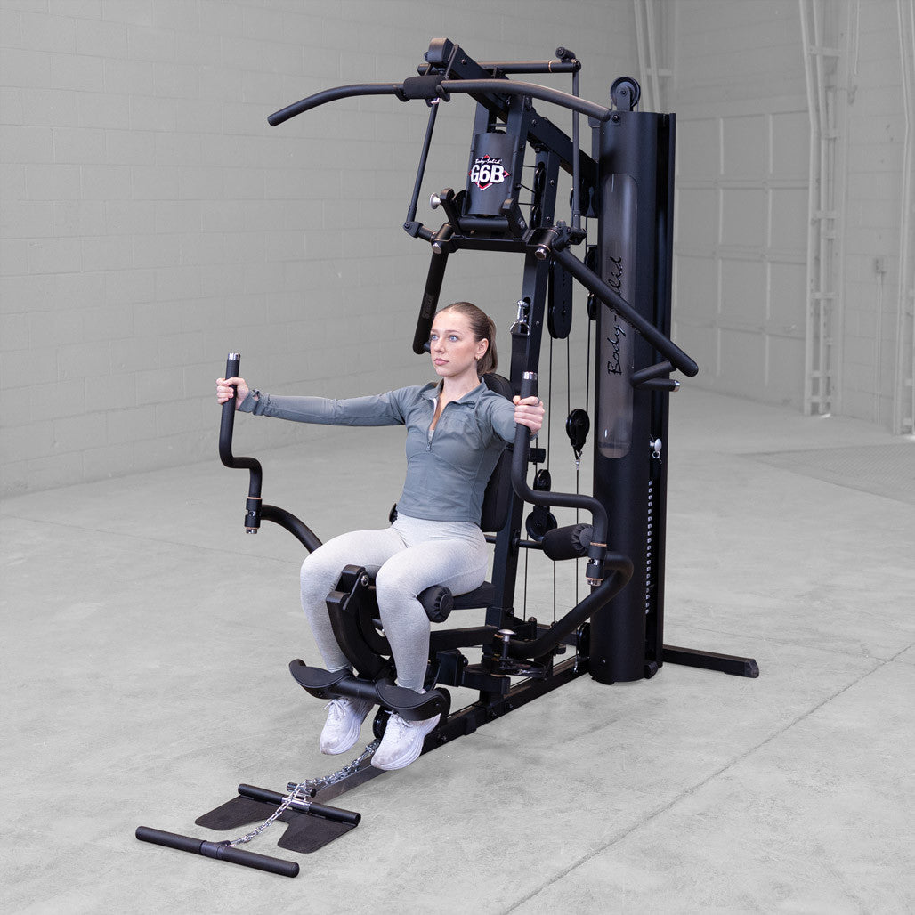 Body-Solid G6B gym in use with seated chest press