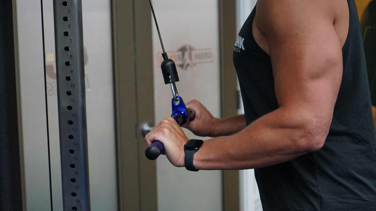 Gronk Fitness curl bar in use during tricep exercise