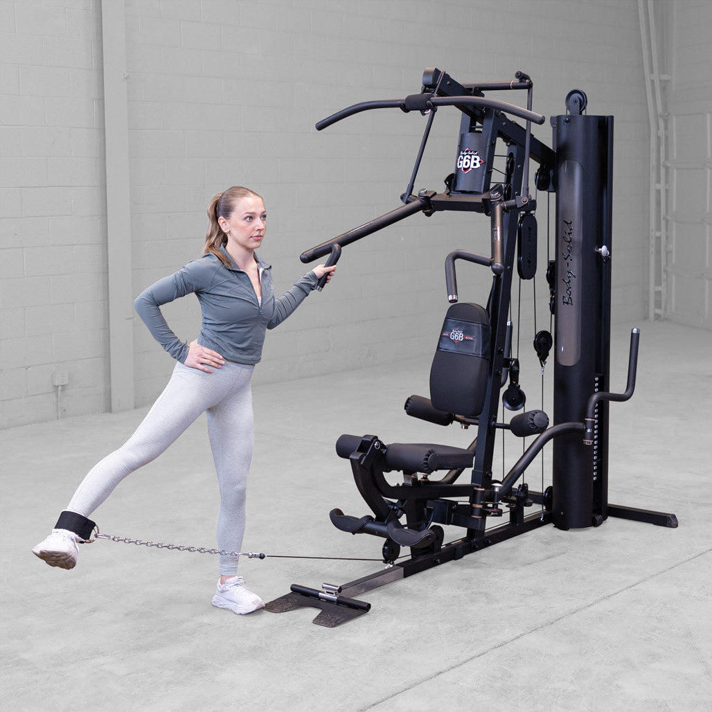 Body-Solid G6B gym in use with leg extension