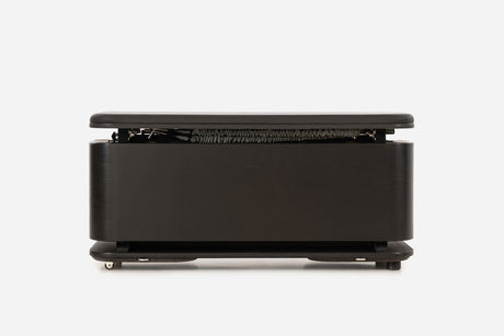 Front view of a black storage bench with the padded lid raised and resistance bands visible inside