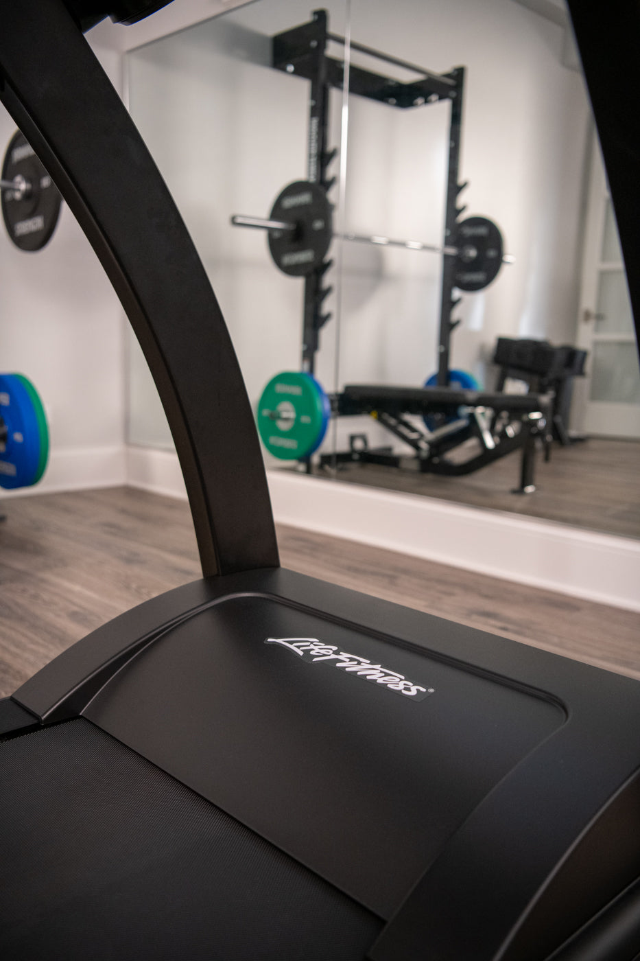 Run CX treadmill motor housing and Life Fitness logo in a home gym setting